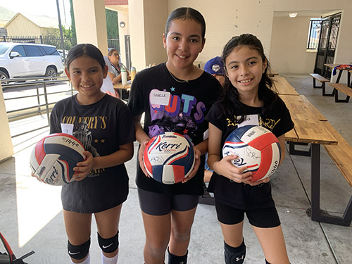 studentClinic Image of 3 students holding volleyballs